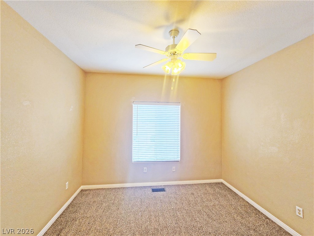 1421 Star Road, Unit 2 Pahrump, NV 89048 - Photo 18 of 33 Carpeted empty room with baseboards, a ceiling fan, and visible vents