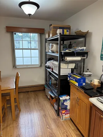 a kitchen with stainless steel appliances granite countertop a stove and a wooden floors