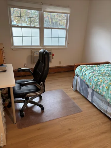 a bedroom with furniture and a window