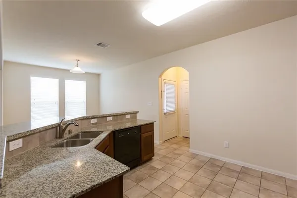 a kitchen with stainless steel appliances granite countertop a sink stove and cabinets