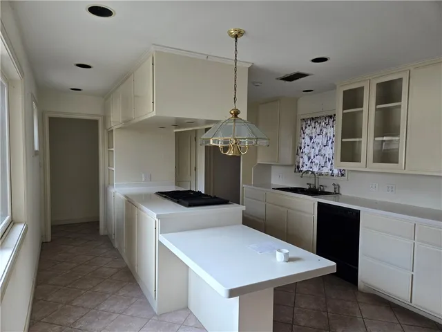 a kitchen with stainless steel appliances granite countertop a sink a stove and a refrigerator