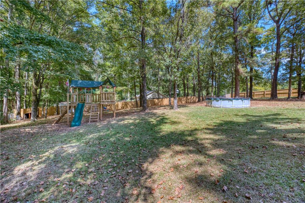 25 Lee Road Salem, AL 36874 - Photo 23 of 30 Fenced backyard with an outdoor pool and a playground