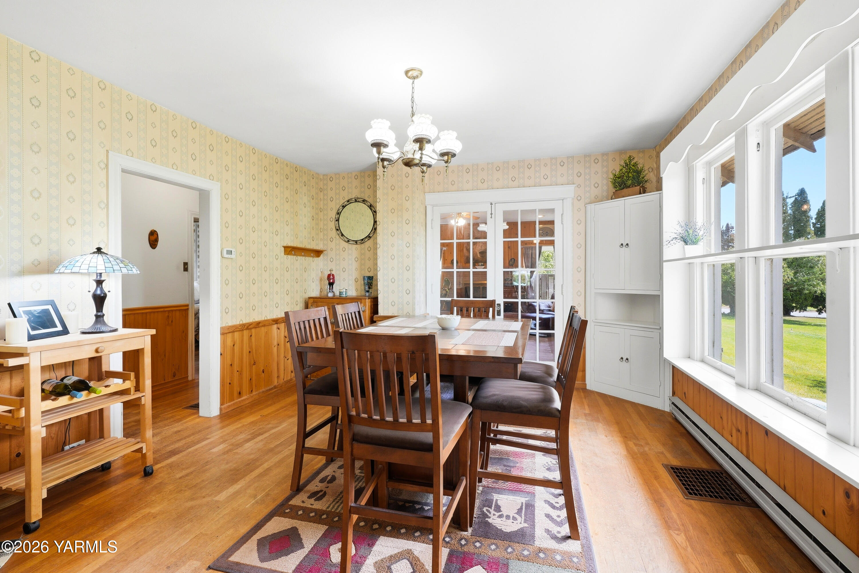 690 North Gleed Road Naches, WA 98937 - Photo 7 of 60 a dining room with furniture a chandelier and wooden floor