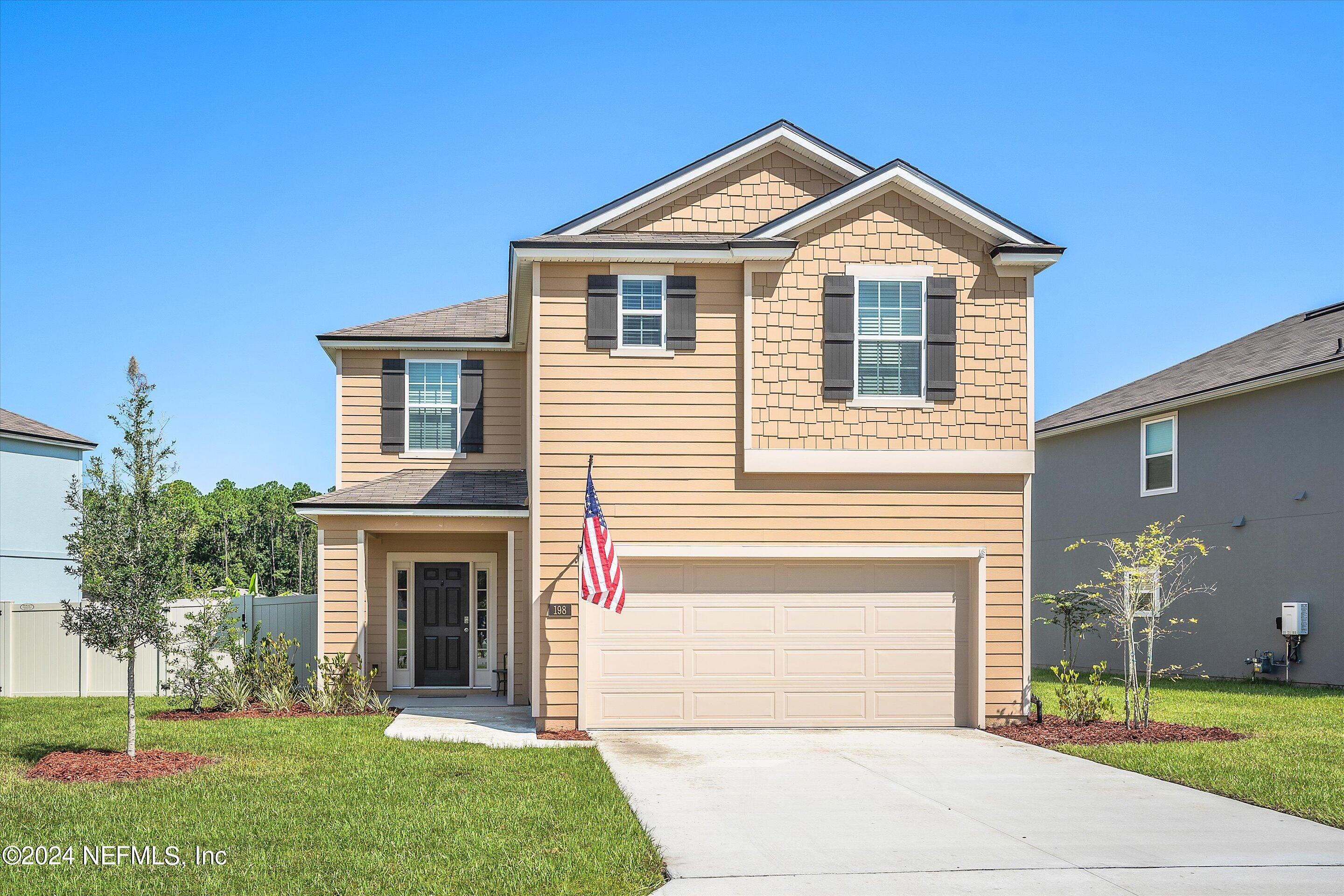 198 Caminha Road St. Augustine, FL 32084 - Photo 1 of 43 a front view of a house with a yard and garage