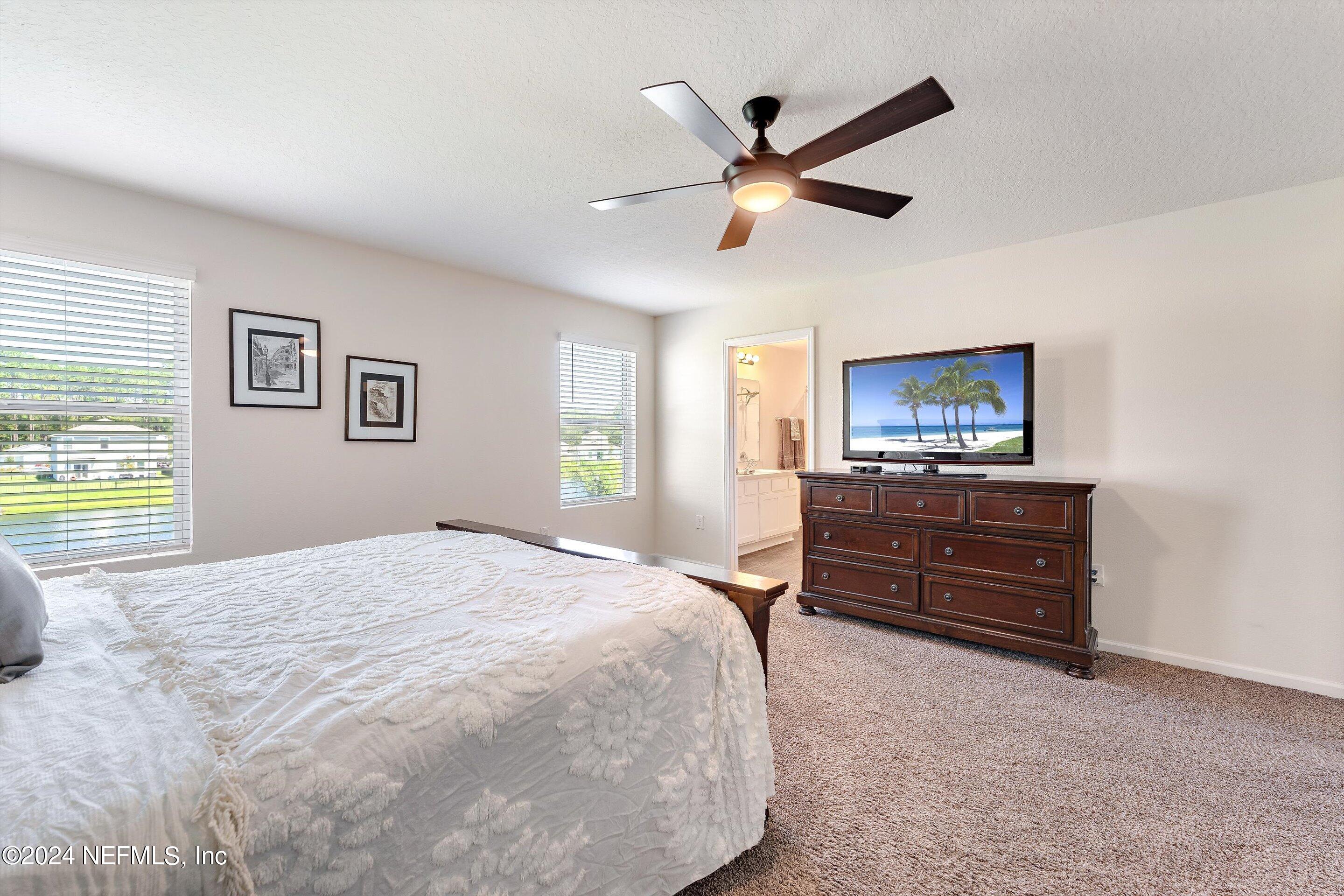 198 Caminha Road St. Augustine, FL 32084 - Photo 18 of 43 a bed room with a bed and a television