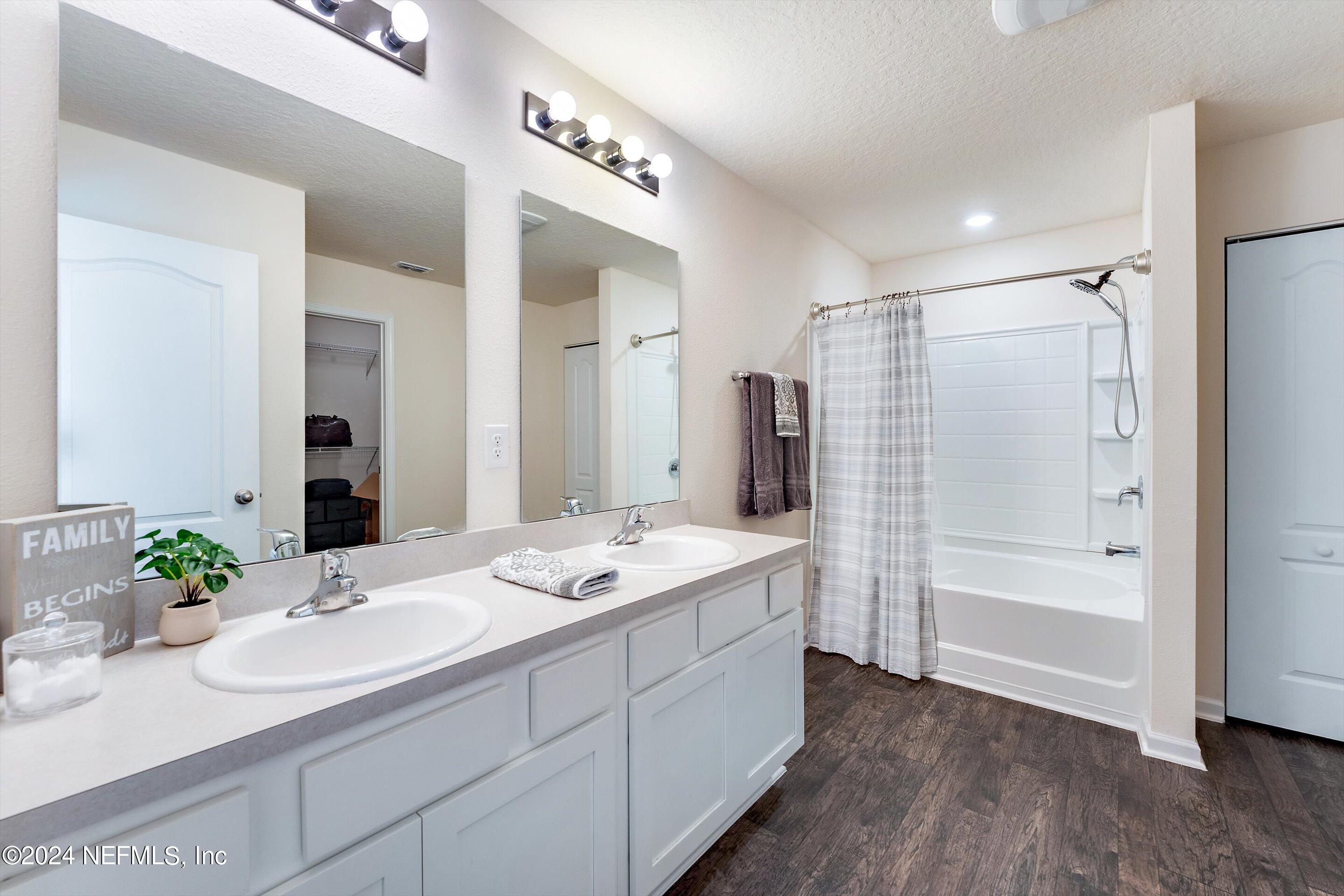 198 Caminha Road St. Augustine, FL 32084 - Photo 19 of 43 a bathroom with a sink double vanity granite tub shower and a mirror