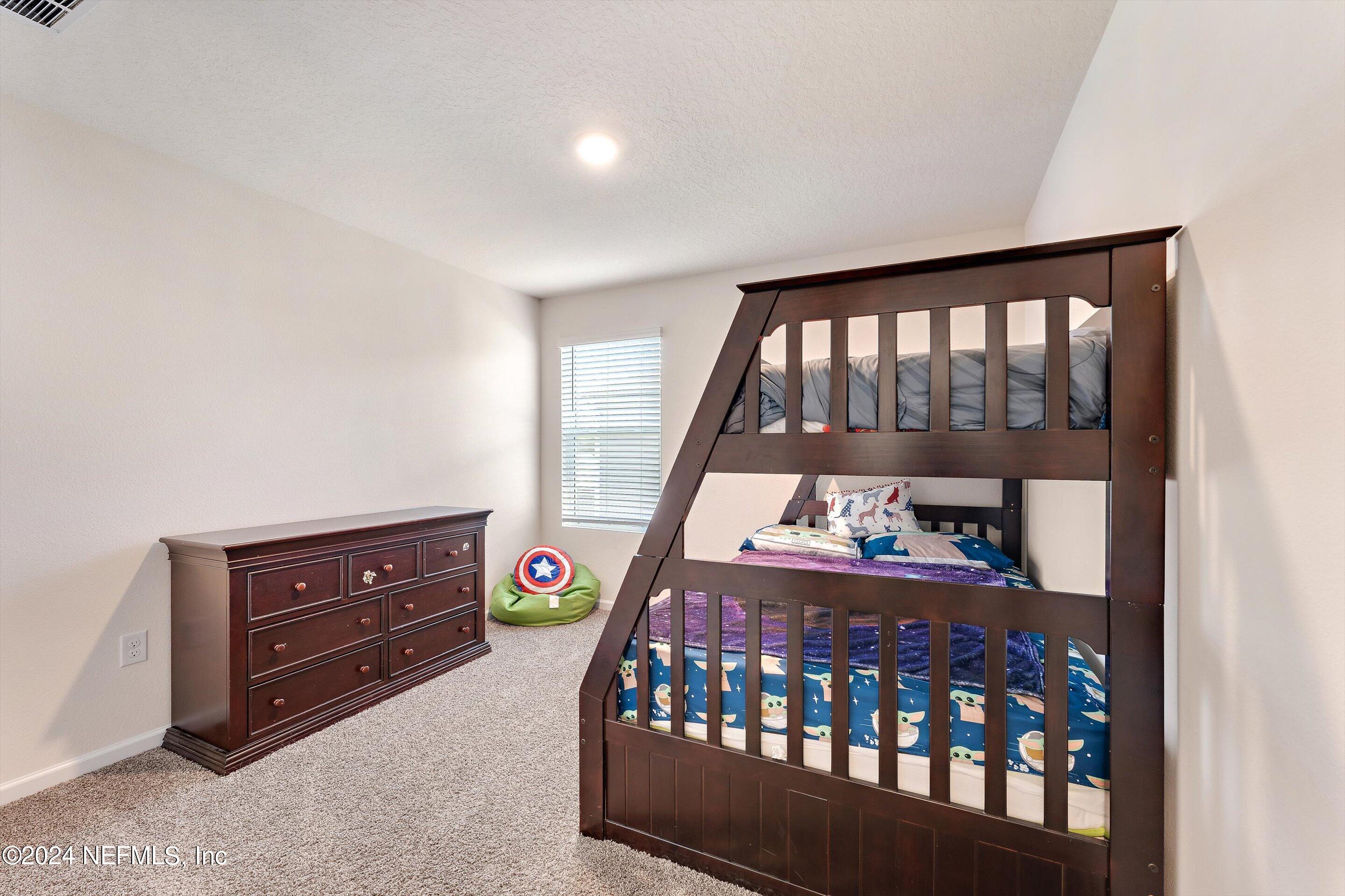 198 Caminha Road St. Augustine, FL 32084 - Photo 20 of 43 a bedroom with furniture a baby crib and a window