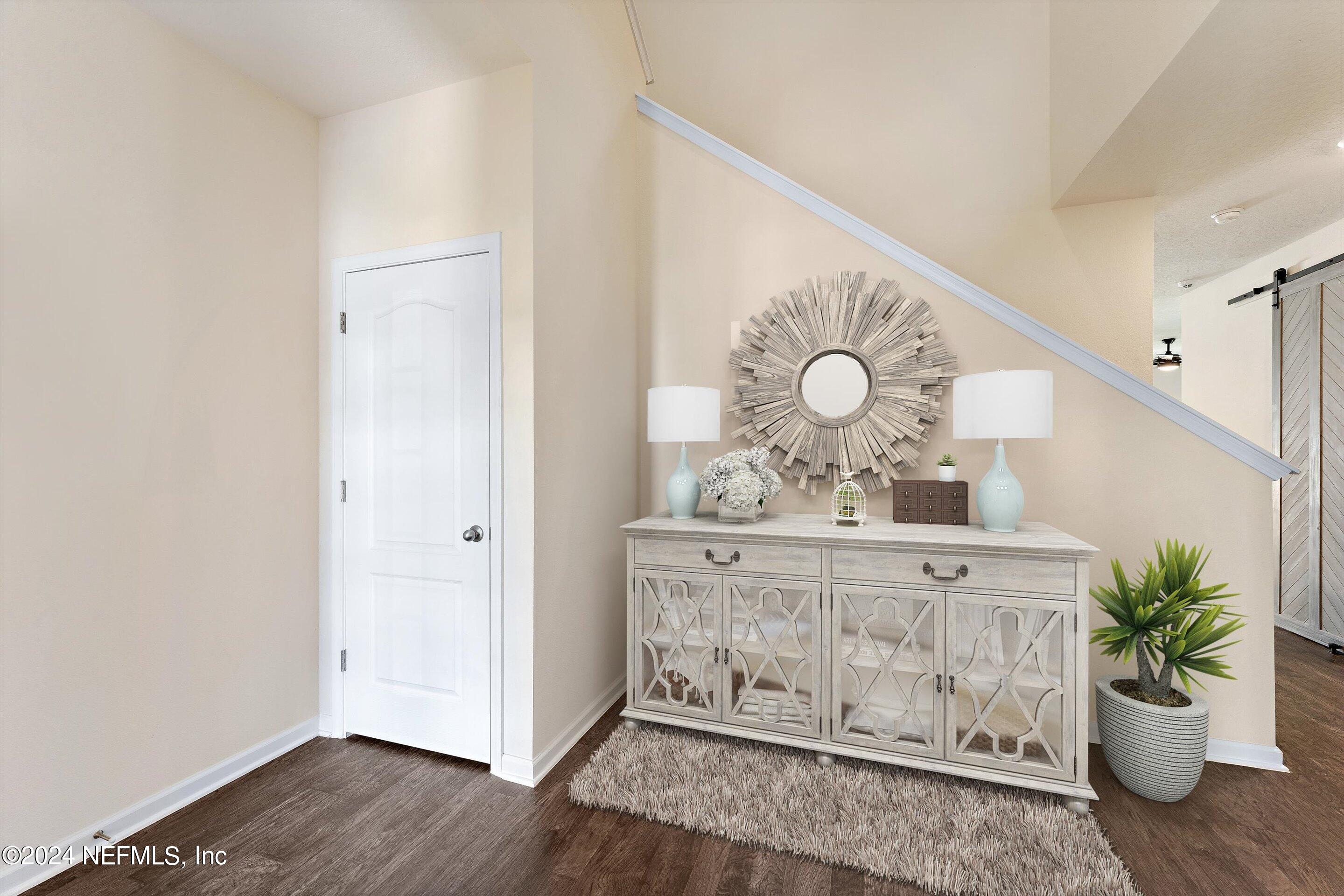 198 Caminha Road St. Augustine, FL 32084 - Photo 3 of 43 a view of a hallway with wooden floor and a potted plant