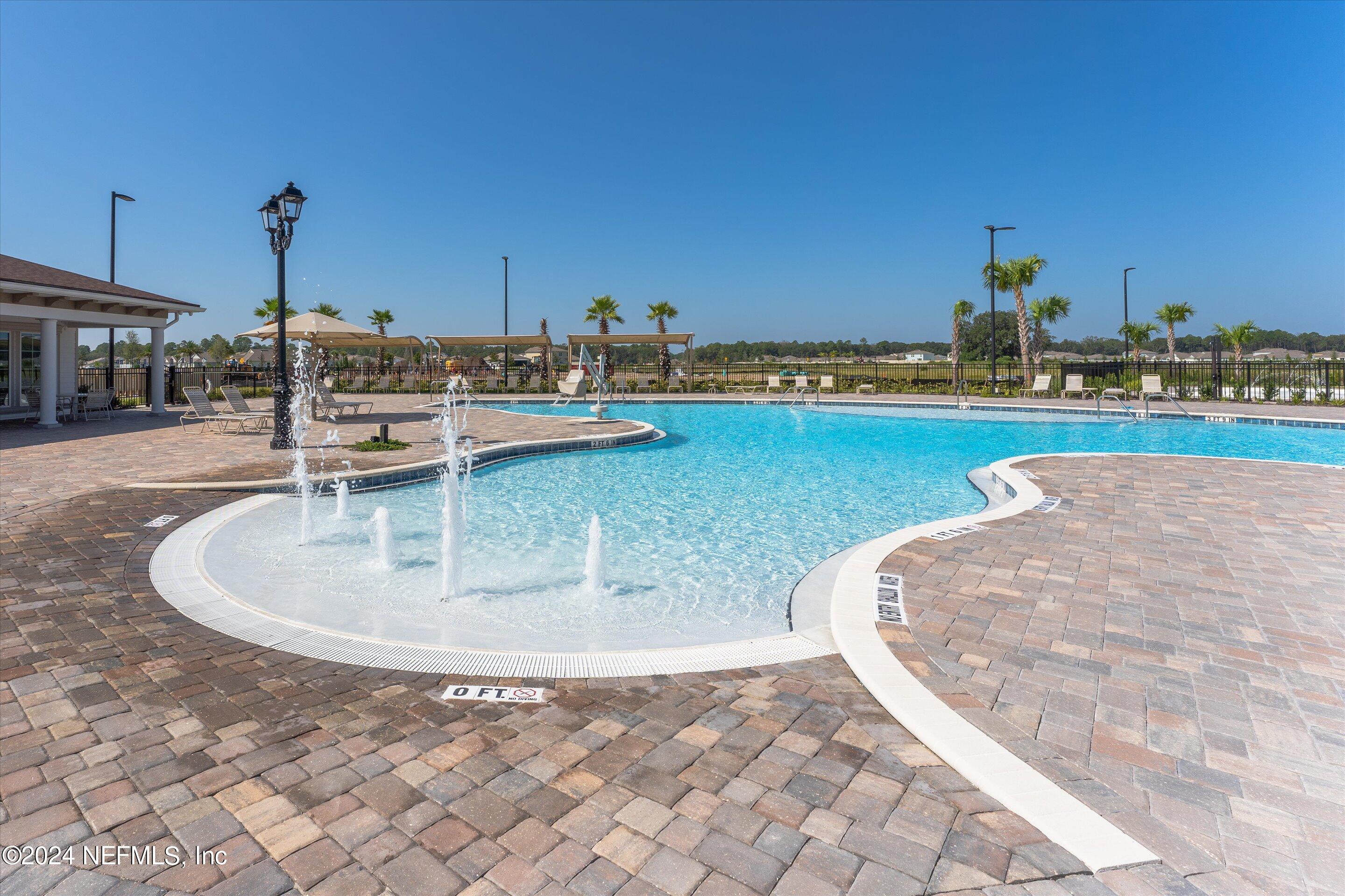 198 Caminha Road St. Augustine, FL 32084 - Photo 31 of 43 a view of a swimming pool and lake