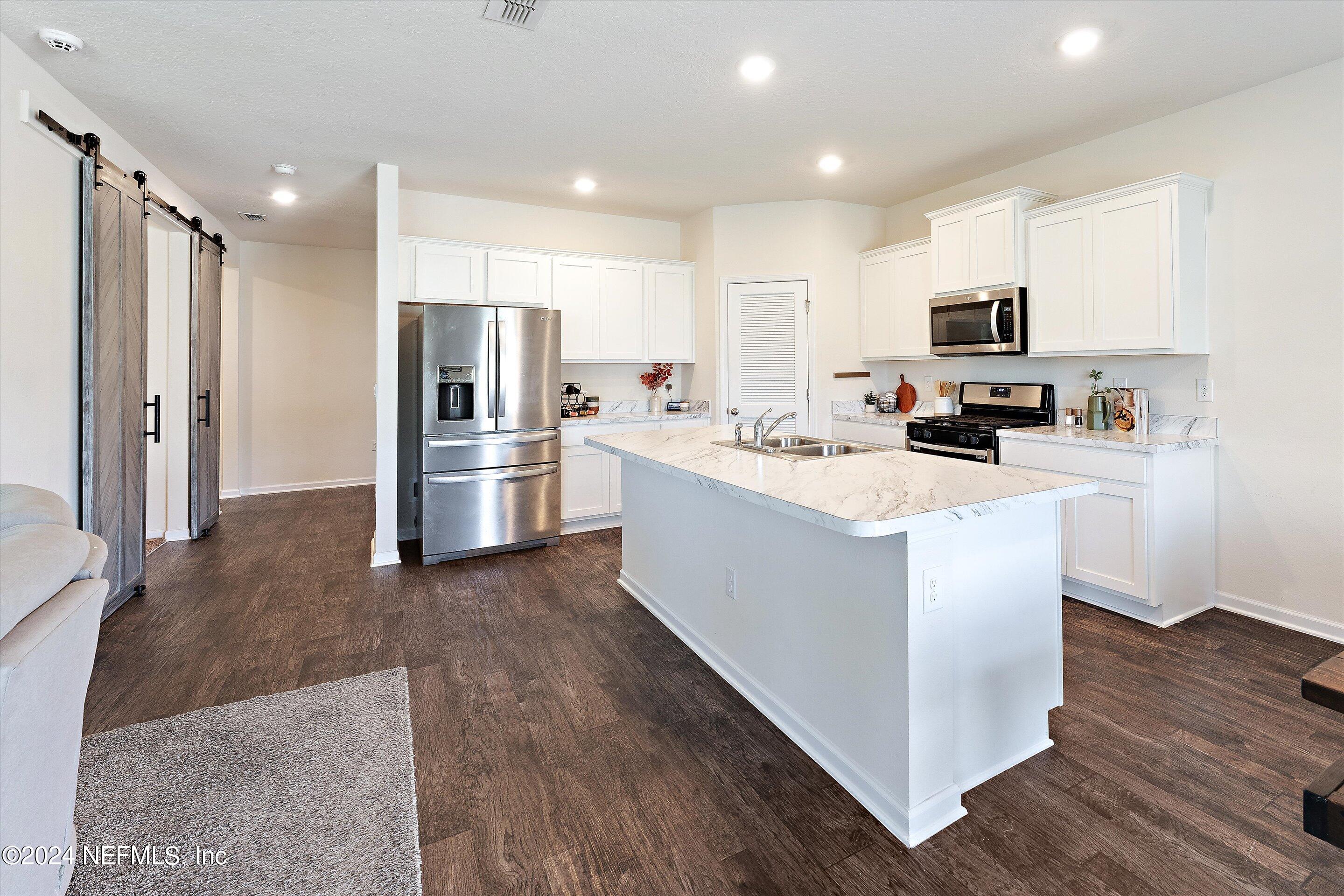 198 Caminha Road St. Augustine, FL 32084 - Photo 7 of 43 a kitchen with refrigerator and cabinets