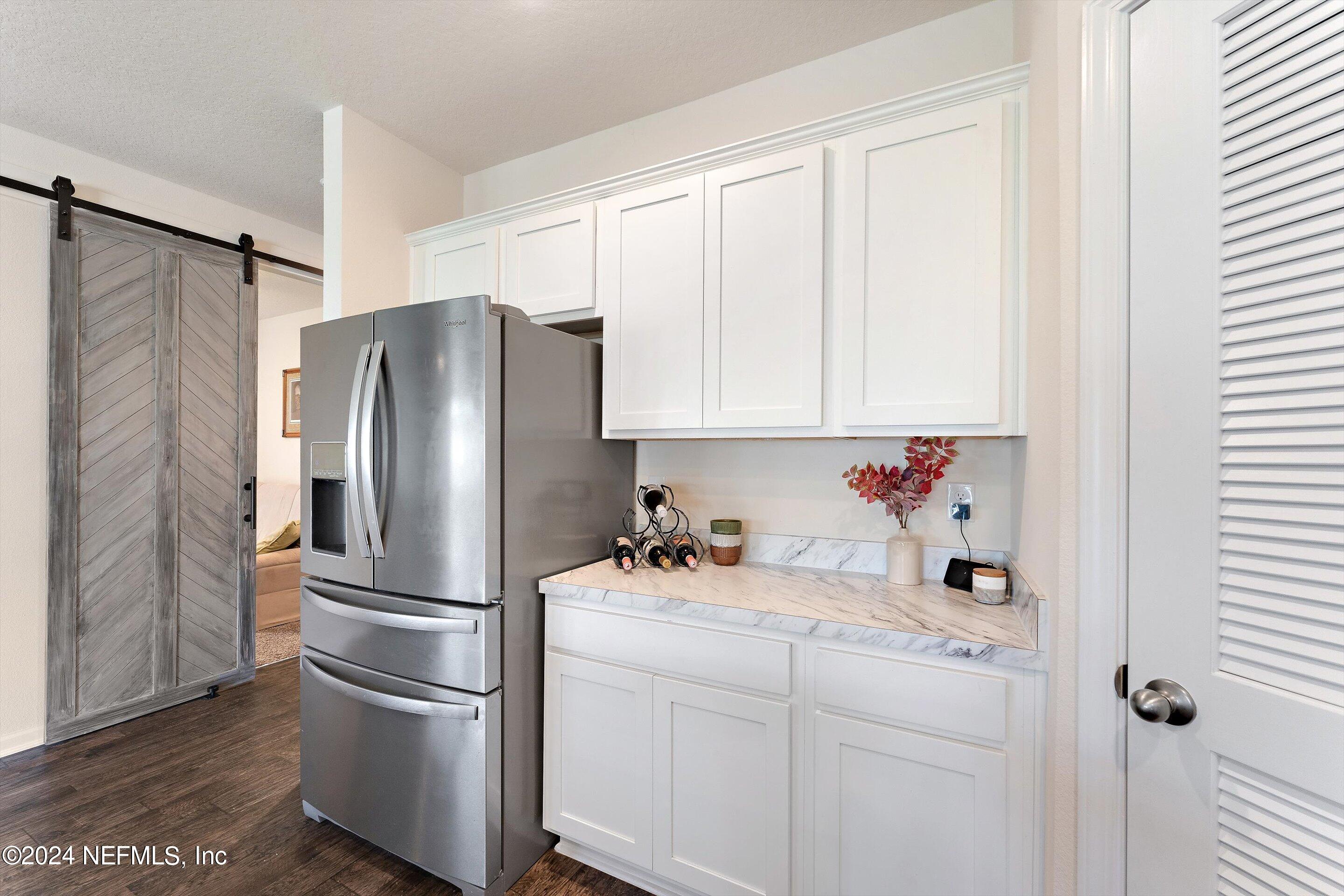198 Caminha Road St. Augustine, FL 32084 - Photo 8 of 43 a kitchen with stainless steel appliances a refrigerator sink and cabinets