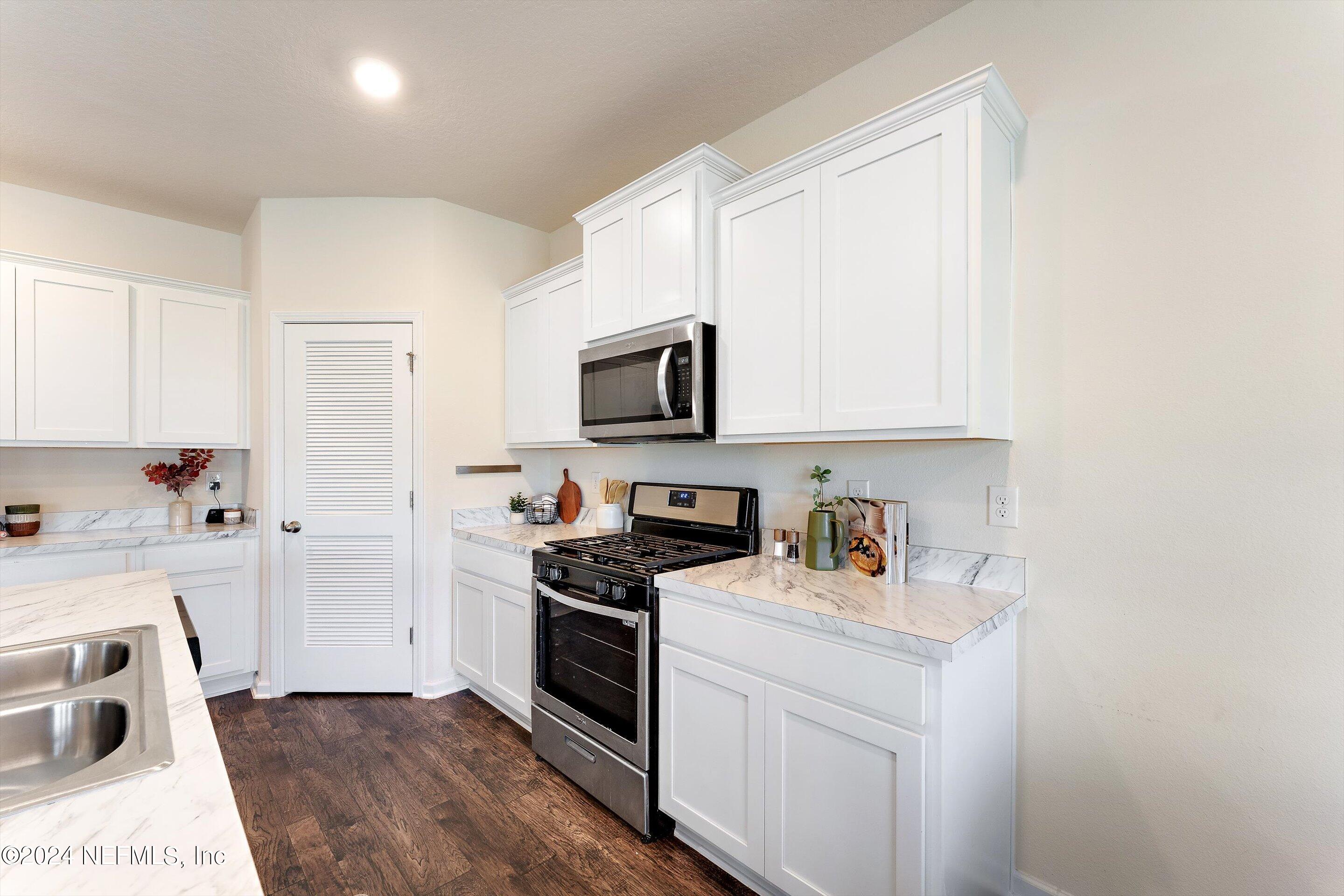 198 Caminha Road St. Augustine, FL 32084 - Photo 9 of 43 a kitchen with a sink stove and refrigerator