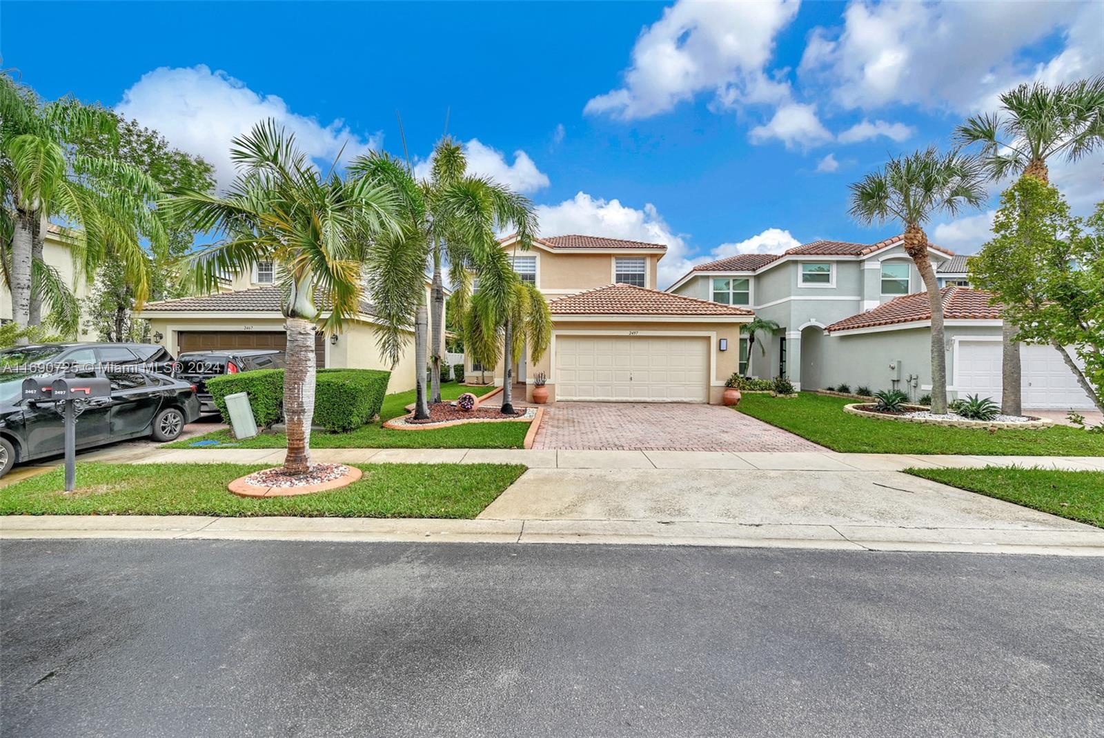 2497 Southwest 163rd Avenue Miramar, FL 33027 - Photo 1 of 50 a front view of a house with a yard and trees