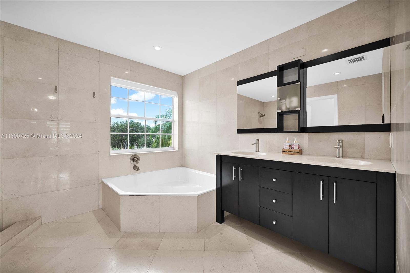 2497 Southwest 163rd Avenue Miramar, FL 33027 - Photo 32 of 50 a spacious bathroom with a bathtub sink and mirror