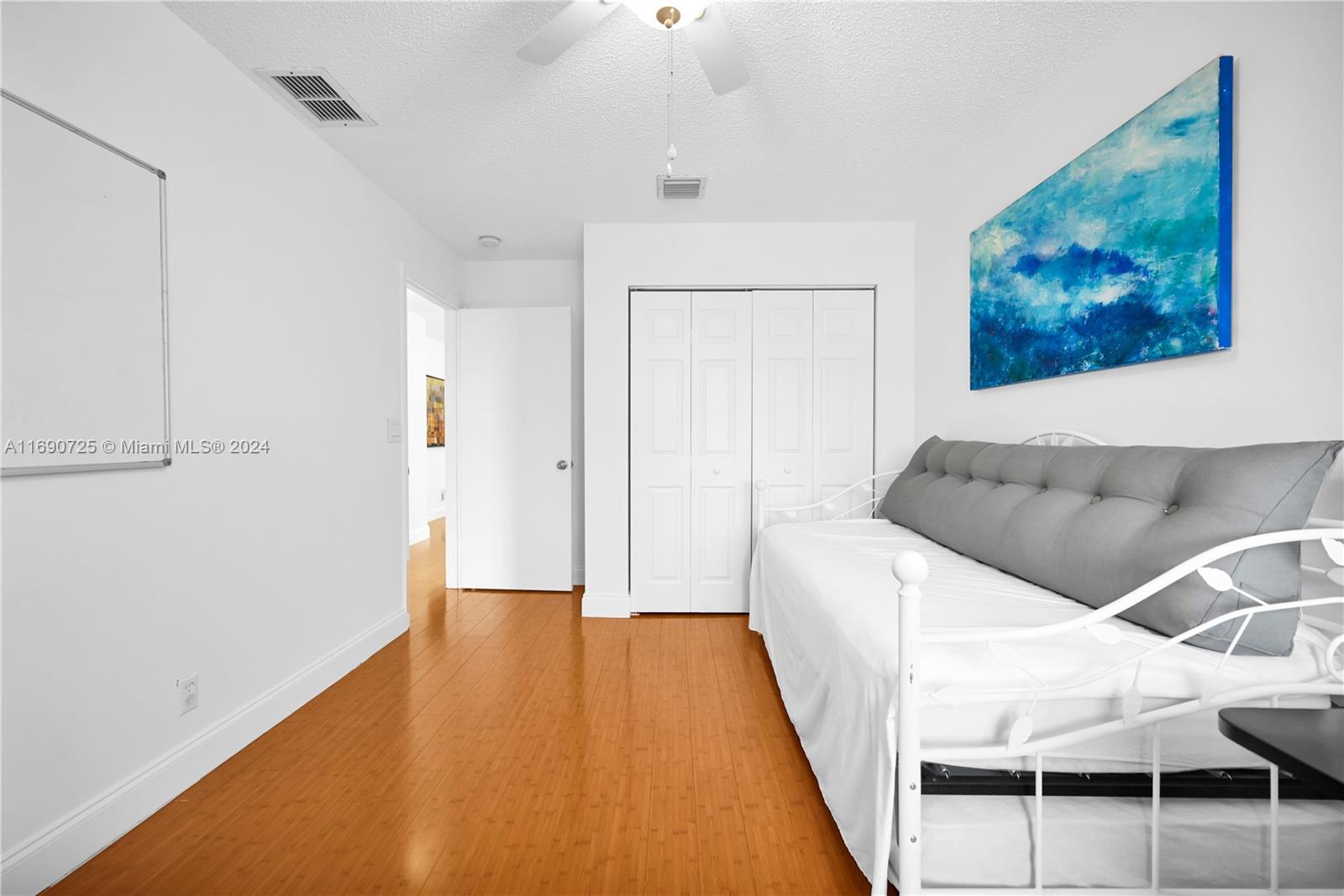 2497 Southwest 163rd Avenue Miramar, FL 33027 - Photo 39 of 50 a hallway with sliding door and wooden floor