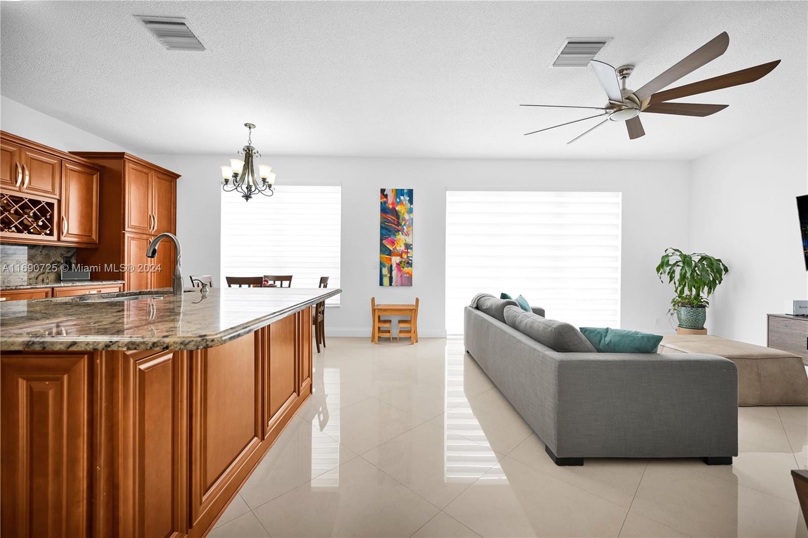 2497 Southwest 163rd Avenue Miramar, FL 33027 - Photo 7 of 50 a living room with furniture and a chandelier