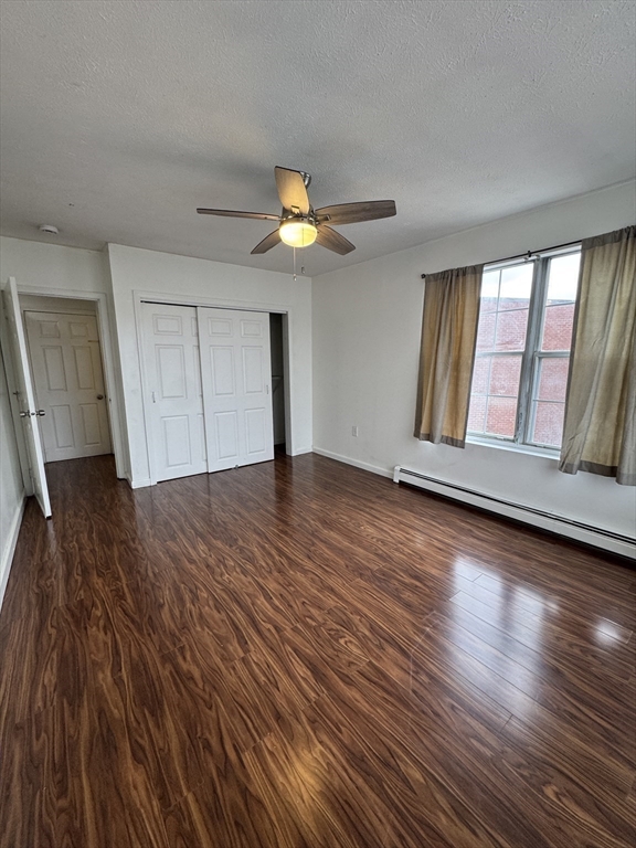 20 Knox Street, Unit 23 Lawrence, MA 01841 - Photo 11 of 15 an empty room with wooden floor and windows