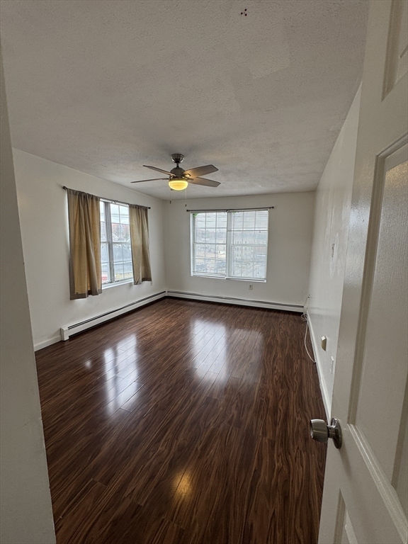 20 Knox Street, Unit 23 Lawrence, MA 01841 - Photo 12 of 15 a view of an empty room with wooden floor and a window
