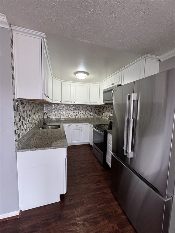 20 Knox Street, Unit 23 Lawrence, MA 01841 - Photo 2 of 15 a kitchen with a sink a refrigerator and cabinets