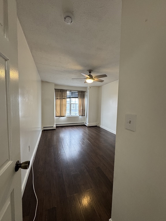 20 Knox Street, Unit 23 Lawrence, MA 01841 - Photo 8 of 15 an empty room with wooden floor and windows