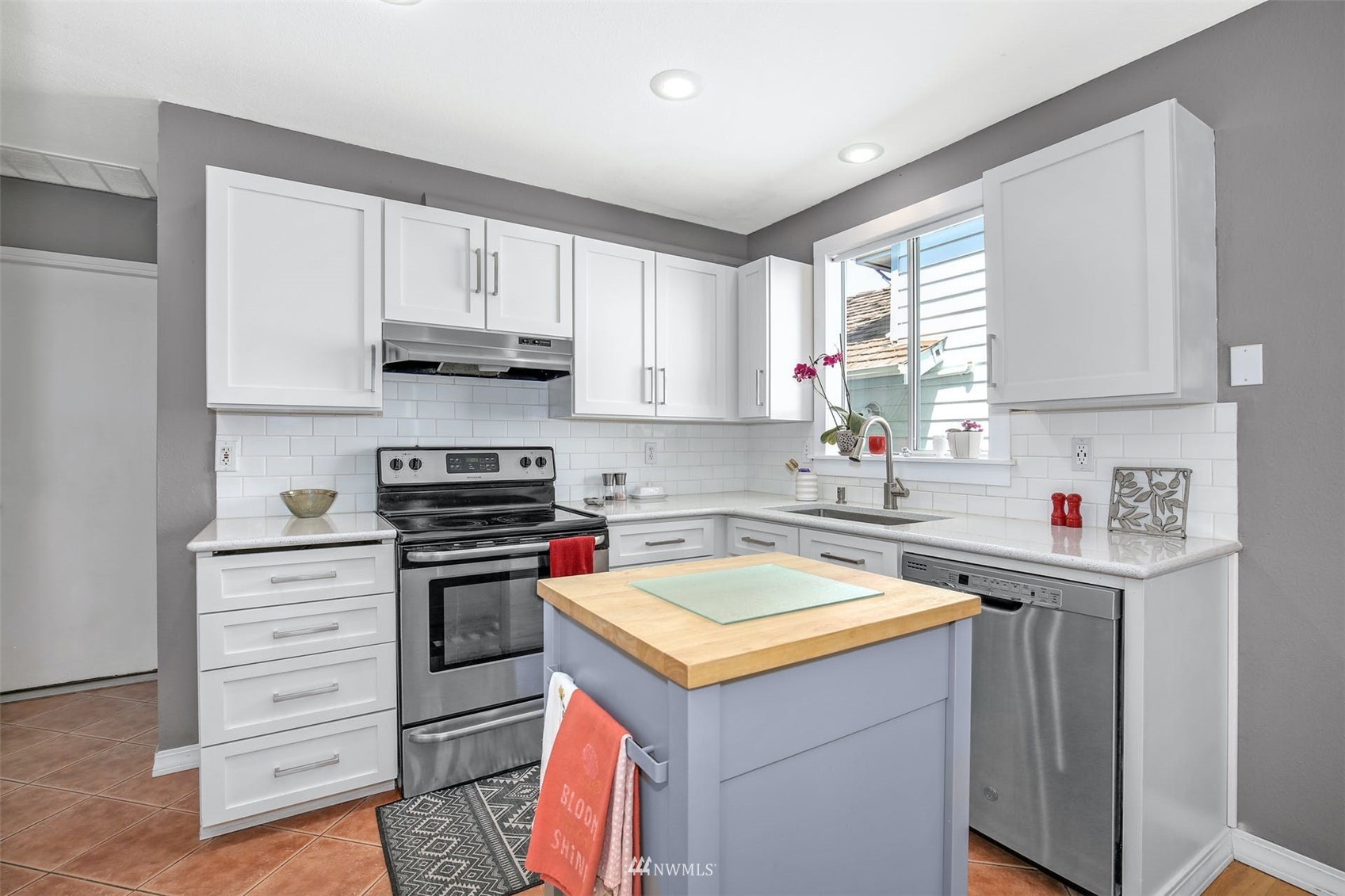 2057 Southeast 8th Place Renton, WA 98057 - Photo 8 of 23 a kitchen with a sink a stove and cabinets