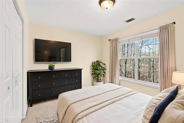 a bedroom with a bed and a flat screen tv