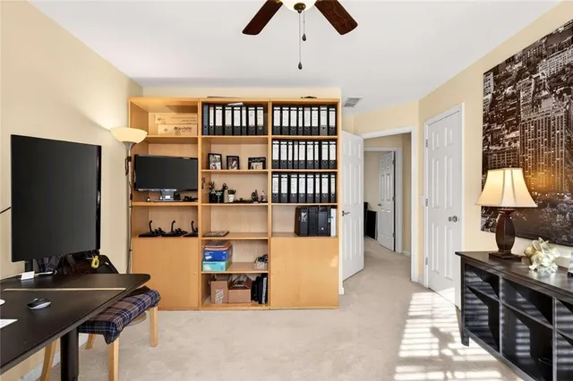 a dining room with furniture and a flat screen tv