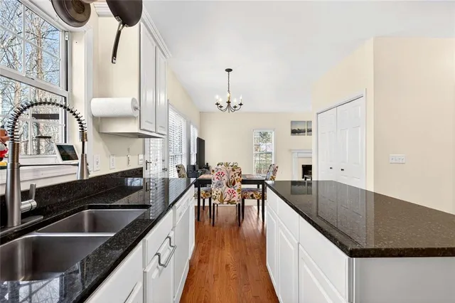 a kitchen with granite countertop a sink and cabinets