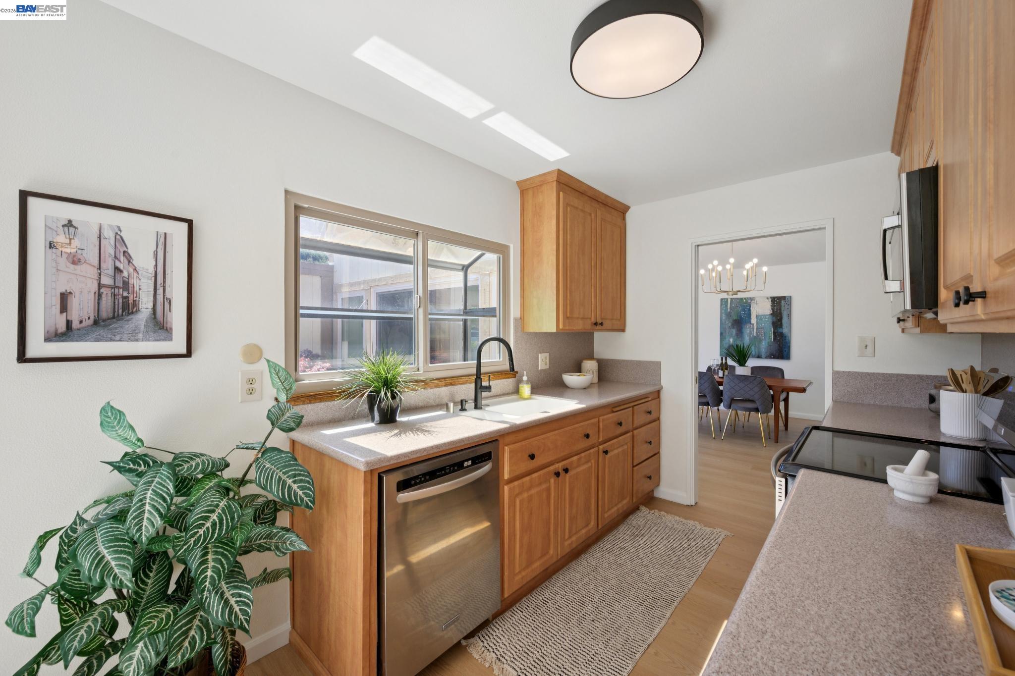 3201 Phoenix Lane Alameda, CA 94502 - Photo 16 of 58 a kitchen with stainless steel appliances granite countertop a stove a sink and a microwave