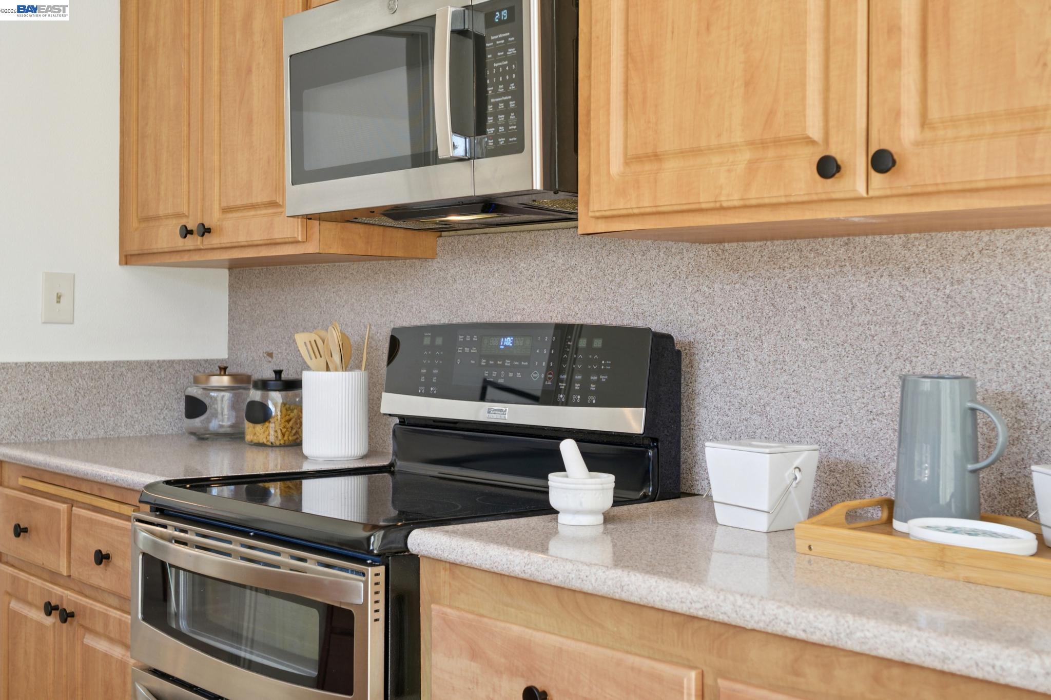 3201 Phoenix Lane Alameda, CA 94502 - Photo 18 of 58 a kitchen with stainless steel appliances granite countertop a stove and a white cabinets