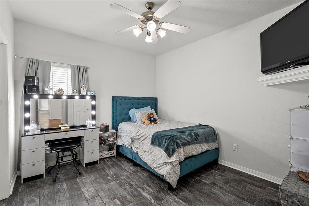 3696 Old Lorena Road Lorena, TX 76655 - Photo 21 of 27 Room featuring dark wood-finish flooring and a ceiling fan with integrated lighting