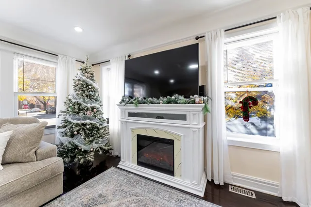 a living room with a fireplace and a large window
