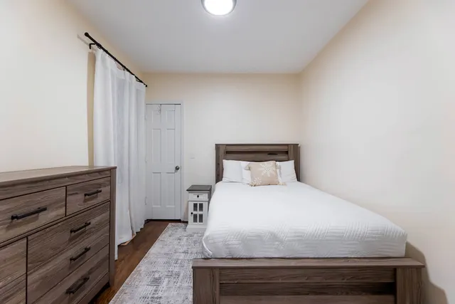 a bedroom with a bed and a dresser