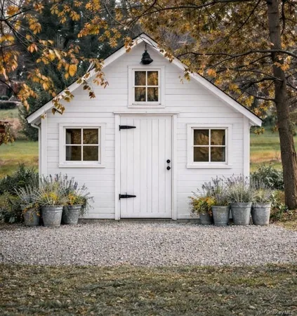 a front view of a house with sitting area