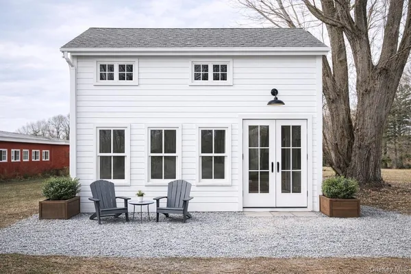 a backyard of a house with yard and outdoor seating