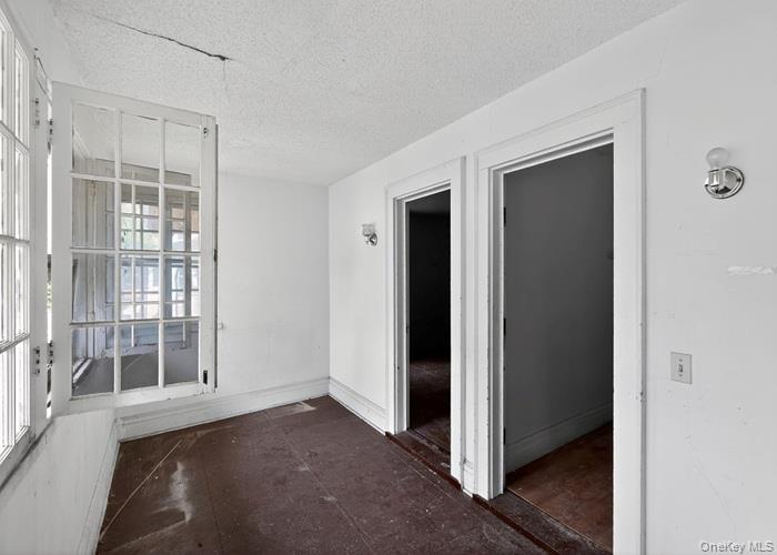 63 Rugby Avenue Rochester, NY 14619 - Photo 13 of 23 an empty room with windows