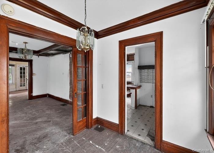 63 Rugby Avenue Rochester, NY 14619 - Photo 14 of 23 a view of a hallway and a room with wooden floor