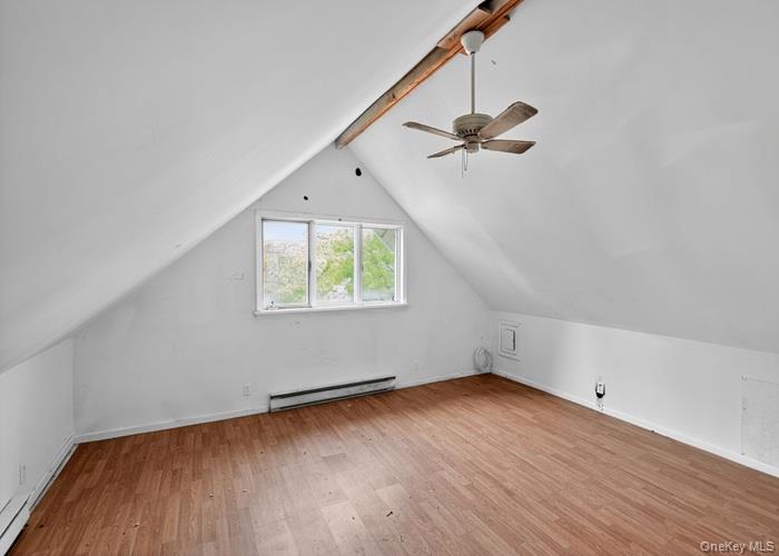 63 Rugby Avenue Rochester, NY 14619 - Photo 17 of 23 an empty room with wooden floor chandelier fan and windows