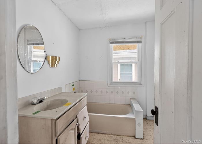 63 Rugby Avenue Rochester, NY 14619 - Photo 20 of 23 a bathroom with a tub sink and mirror