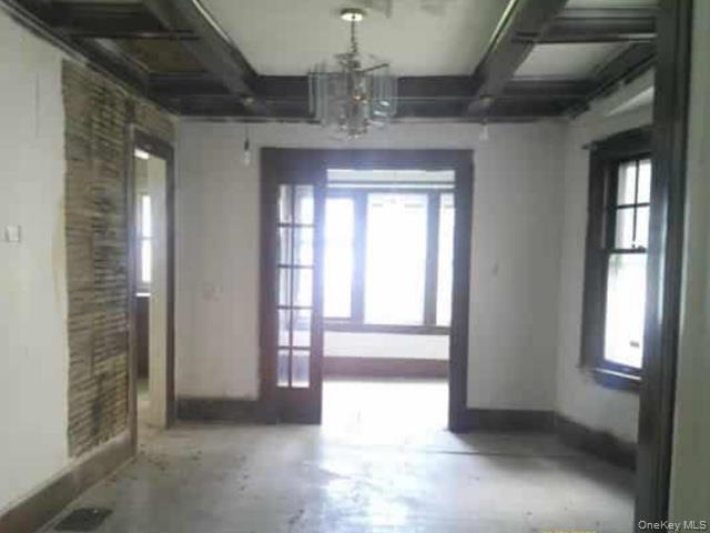 63 Rugby Avenue Rochester, NY 14619 - Photo 4 of 23 a view of a hallway with windows and chandelier