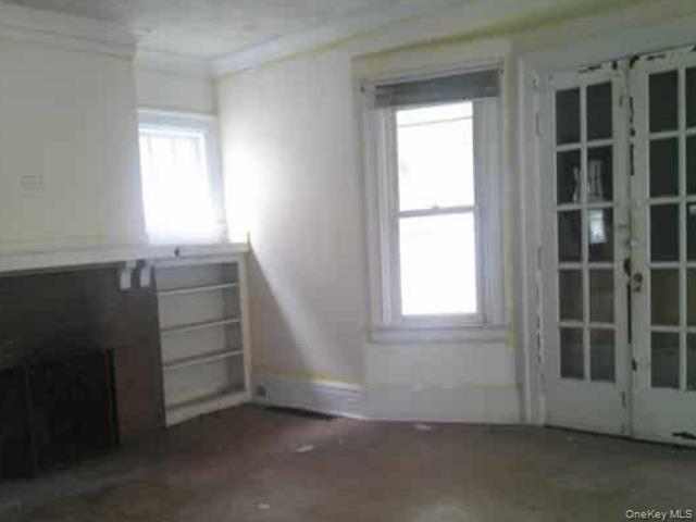 63 Rugby Avenue Rochester, NY 14619 - Photo 5 of 23 an empty room with windows