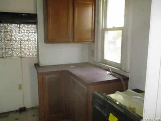 63 Rugby Avenue Rochester, NY 14619 - Photo 6 of 23 a room with window and cabinet