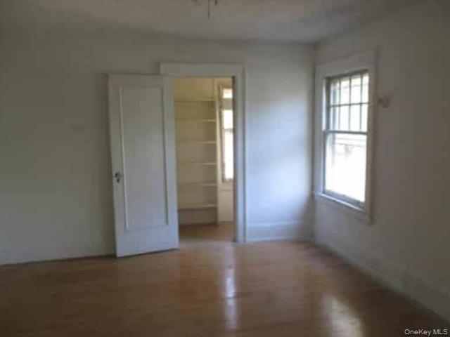 63 Rugby Avenue Rochester, NY 14619 - Photo 8 of 23 an empty room with windows and closet