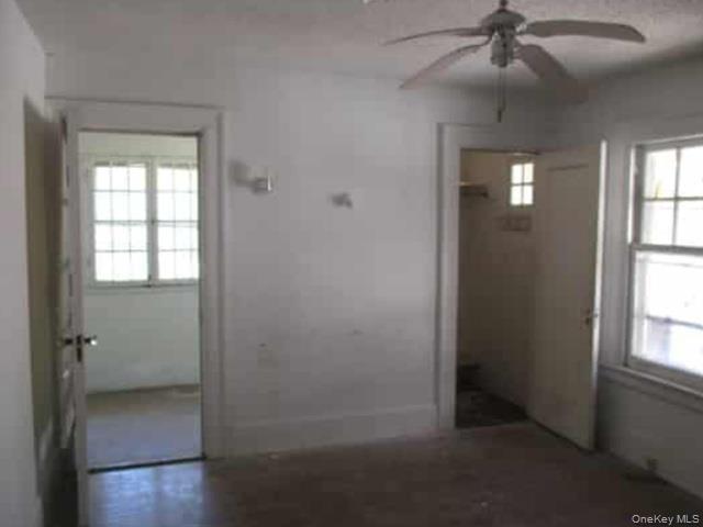 63 Rugby Avenue Rochester, NY 14619 - Photo 9 of 23 wooden floor in an empty room with a window