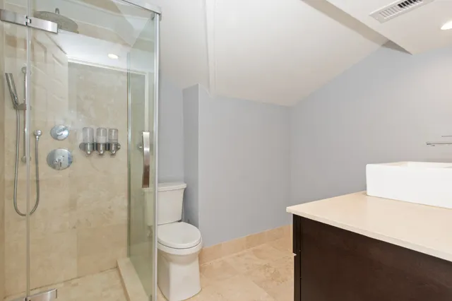 a bathroom with a shower a toilet and sink