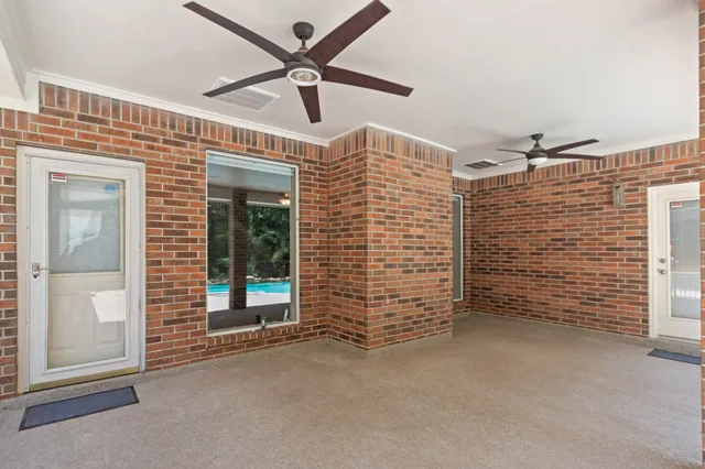 a view of an empty room with a ceiling fan