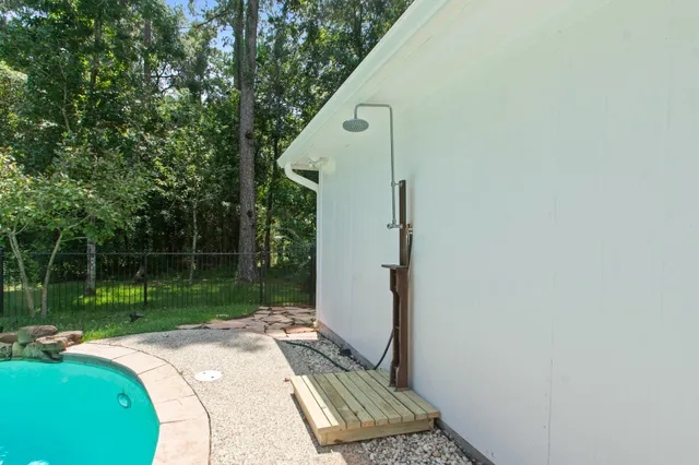a backyard of a house with lots of green space and glass windows