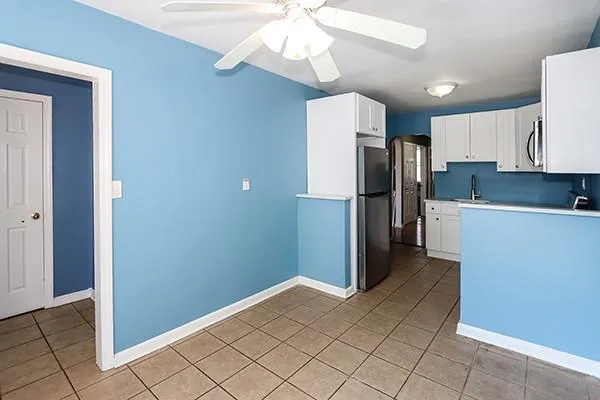 a kitchen with stainless steel appliances a refrigerator and a stove top oven