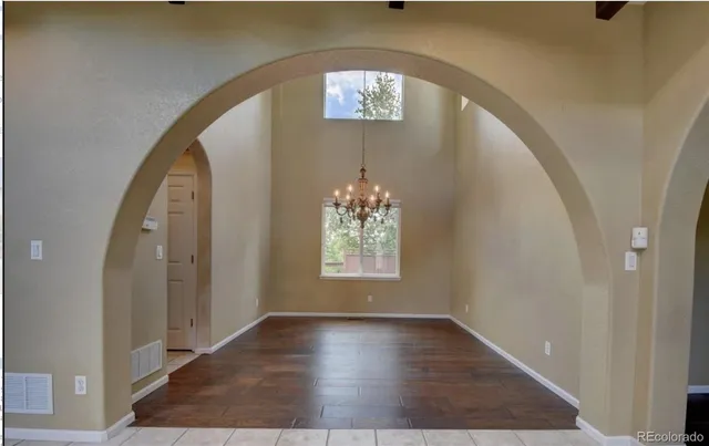 a view of an entryway with wooden floor