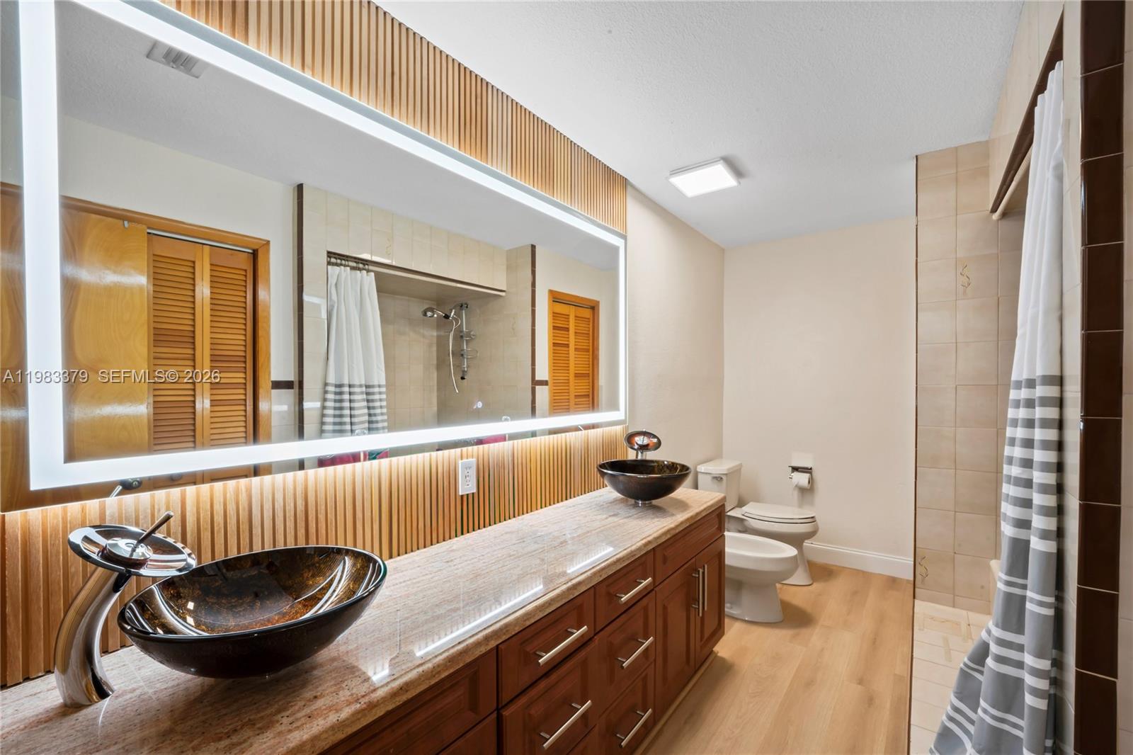 10320 Southwest 139th Street Miami, FL 33176 - Photo 14 of 100 a bathroom with a granite countertop sink and a large mirror